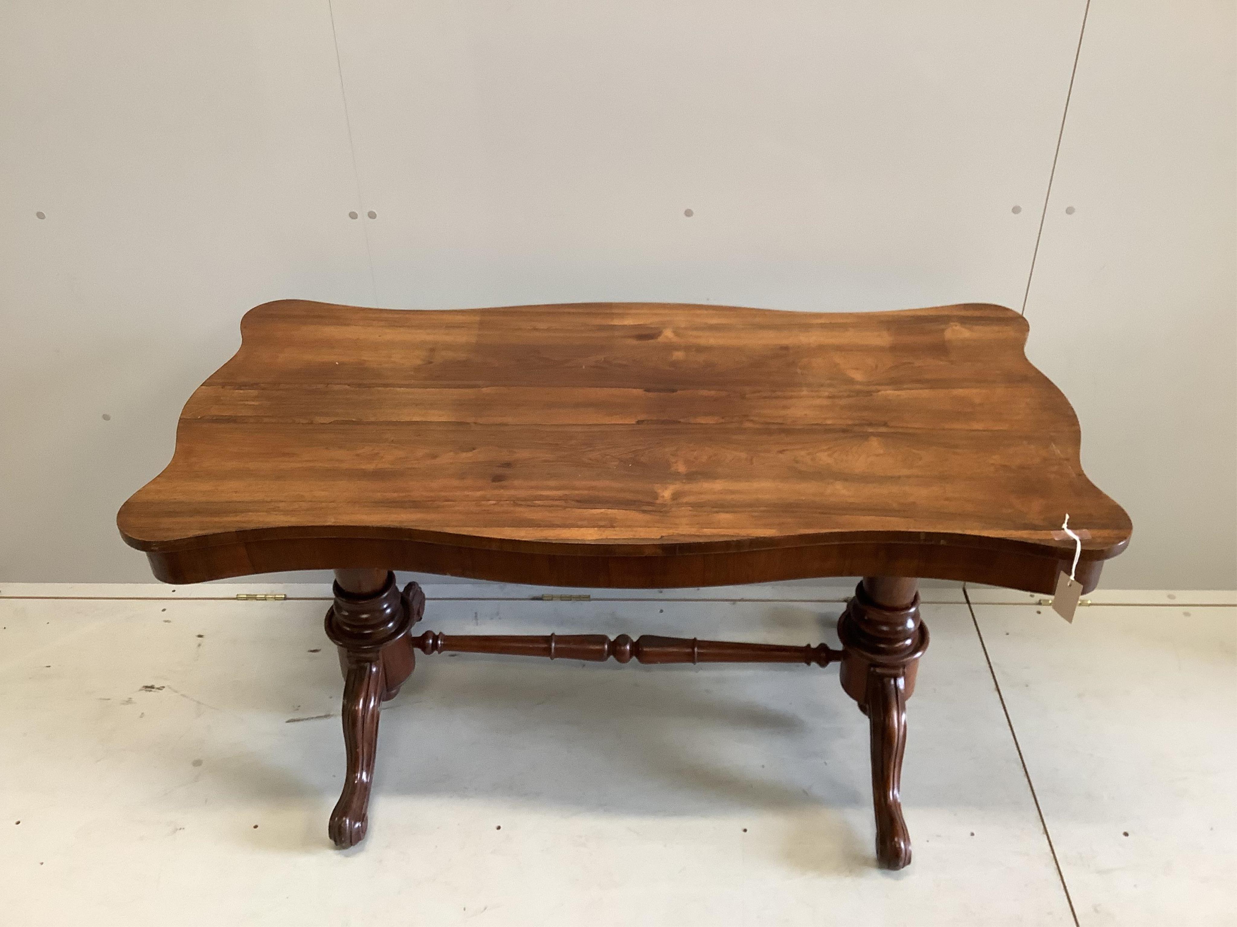 A Victorian rosewood serpentine centre table, width 137cm, depth 69cm, height 73cm. Condition - fair